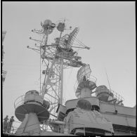 [Vue en contre-plongée de l'antenne radar du croiseur Colbert dans le port d'Oran.]