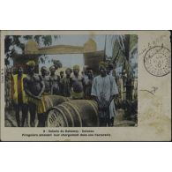 3 - Colonie du Dahomey - Cotonou. Piroguiers amenant leur chargement dans une Factorerie. Cliché M. O. [légende d'origine]