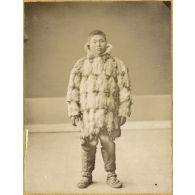 [Portrait en pied d'un habitant de type asiatique de la Sibérie vêtu de fourrures et de bottes de peau].