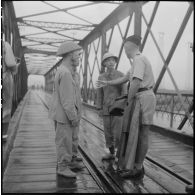 Conversation entre trois soldats de l'APVN (Armée populaire vietnamienne) et un officier du CEFEO (Corps expéditionnaire français en Extrême-Orient) sur le pont Paul-Doumer (aujourd'hui Long Biên).