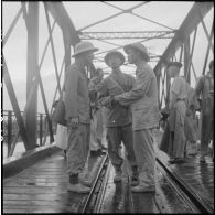 Trois soldats de l'APVN (Armée populaire vietnamienne) s'entretiennent sur le pont Paul-Doumer (aujourd'hui Long Biên).