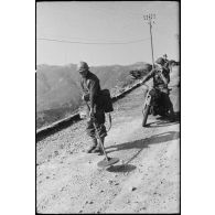 Un sapeur du 82e bataillon du génie (BG) relève des mines avec un détecteur sur une route menant à Bastia.