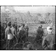 Le caméraman du SCA (Service cinématographique de l'armée) Roger Montéran, muni de sa caméral Bell & Howell, se trouve parmi des soldats allemands, appartenant probablement à la 71. Infanterie-Division (division d'infanterie) et faits prisonniers lors de la prise de Castelforte par la 3e DIA (division d'infanterie algérienne).
