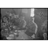 Le colonel (Oberstleutnant) Götsche déjeune en présence d'un général allemand et en compagnie d'officiers de la police allemande.