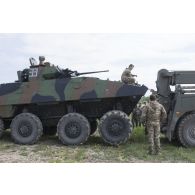 Des mécaniciens britanniques mènent le dépannage d'un véhicule blindé de combat d'infanterie (VBCI) au moyen d'un camion à Tapa, en Estonie.