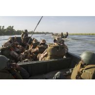 Des soldats du 1er régiment d'infanterie (RI) et des soldats maliens patrouillent sur le fleuve Niger à bord de leur pirogue en direction du village de Kaoïma, au Mali.