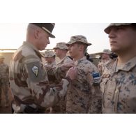 Un officier du 515e régiment du train (RT) remet la médaille d'Outre-mer avec agrafe Sahel à un soldat estonien du bataillon scout à Gao, au Mali.