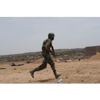 Un soldat malien progresse lors d'un entrainement sur le champ de tir de Koulikoro, au Mali.
