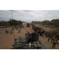 Des habitants saluent au passage des commandos parachutistes de l'air n°20 (CPA 20) à bord de leur véhicule de l'avant blindé (VAB) à Niafounké, au Mali.