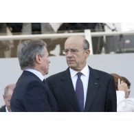 Alain Juppé et Bernard Accoyer en conversation à la tribune lors de la cérémonie du 14 juillet 2011.