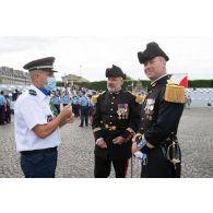 Echange entre un sous-officier de l'administration pénitentiaire et des officiers polytechniciens pendant les derniers préparatifs avant le défilé à pied du 14 juillet sur la place de la Concorde.