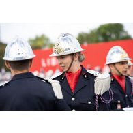 Portrait d'une élève de l'école nationale supérieure des officiers de sapeurs-pompiers (ENSOSP) lors des préparatifs avant le défilé à pied du 14 juillet sur la place de la Concorde.