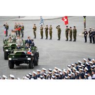 Sur la place de la Concorde, à bord d'un command-car, Emmanuel Macron, président de la République et le général d'armée François Lecointre, chef d'état-major des Armées (CEMA), passent les troupes en revue lors de la cérémonie du 14 juillet 2020.