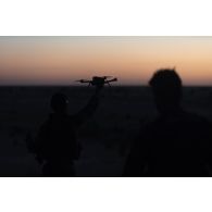 Des soldats du sous-groupement tactique désert (SGTD) Noir envoient un drone reconnaître le terrain autour d'une base opérationnelle avancée temporaire (BOAT) dans la région de Ménaka, au Mali.