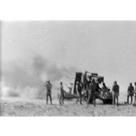 Un canon de 8,8 cm FlaK tire en position, attelée à son avant-train.