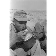 Des soldats allemands mangent dans leurs gamelles.