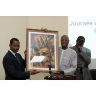 Le ministre malien de la Communication Manga Dembélé remet un tableau au président de la commission Dialogue et réconciliation Mohamed Salia Sokona à l'école du maintien de la paix à Bamako, au Mali.
