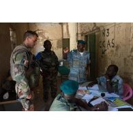 Le lieutenant Nicolas du détachement de liaison et d'appui (DLA) s'informe auprès de gendarmes de la prévôté malienne sur la situation de leurs opérations à Tombouctou, au Mali.