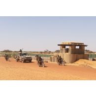 Des soldats maliens progressent à moto et à bord d'un pick-up à Gossi, au Mali.