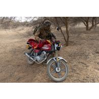 Un légionnaire inspecte une moto lors du ratissage d'une forêt à Tin Salatene, au Mali.