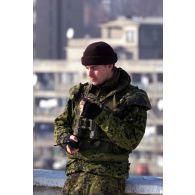Un militaire danois avec ses jumelles et son talkie-walkie fumant la pipe, Mitrovica.