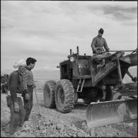Niveleuse et ouvriers français musulmans à la construction de la route dans les monts du Tessala.