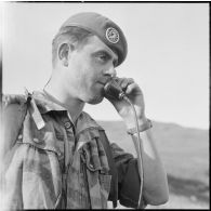 Un commandant de compagnie donne ses instructions par radio.
