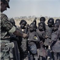 Un soldat français distribue du pain à des enfants tchadiens.