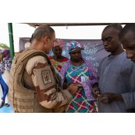 Un aumônier musulman remet un don financier à la présidente de l'institut des jeunes aveugles (IJA) de Gao, au Mali.