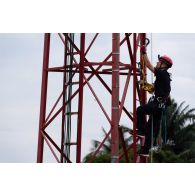Un technicien escalade une antenne du camp de Gaulle à Libreville, au Gabon.