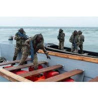 Des soldats congolais fouillent une barque interceptée au centre d'aguerrissement Outre-Mer et étranger (CAOME) de Libreville, au Gabon.