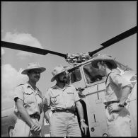 Des officiers devant un hélicoptère Sikorsky H-19 sur le camp de Muong Sai.