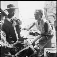 Mme Pidot, assistante sociale, distribue des colis aux soldats de l'Union française libérés à Viet Tri à bord d'un bâtiment de débarquement qui les rapatrie vers Hanoï.