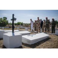Le général de division Jean-Pierre Palasset, commandant la force Barkhane, accompagné d'une délégation d'autorités civiles et militaires françaises et tchadiennes, visite le cimetière de Farcha, dans la périphérie de N'Djamena, lors de la cérémonie du 11 novembre 2014.