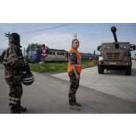 Un soldat du centre de coordination interarmées des transits, transports et mouvements (CCITTM) guide un camion équipé d'un système d'artillerie (CAESAR) en gare de Voila, en Roumanie.
