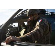 Un soldat communique au moyen de la radio de bord de son véhicule VTA4 pour un départ en mission à Cincu, en Roumanie.