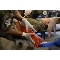 Le personnel du Service de santé des armées (SSA) soigne un blessé au Rôle 1 de cincu, en Roumanie.