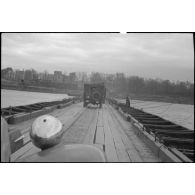 Le véhicule du service cinématographique de l'Armée (SCA) emprunte le pont flottant Mannheim-Ludwigshafen monté par le génie américain le 30 mars 1945.