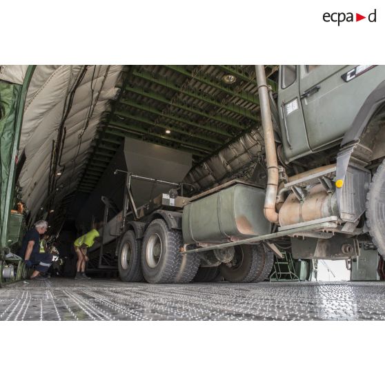 Déchargement d'une centrale d'enrobage à bitume tractée par un camion Renault CBH-380, depuis la soute d'un Antonov An 124-100 stationnant sur le tarmac de la Base aérienne 172 Fort-Lamy à N'Djamena.