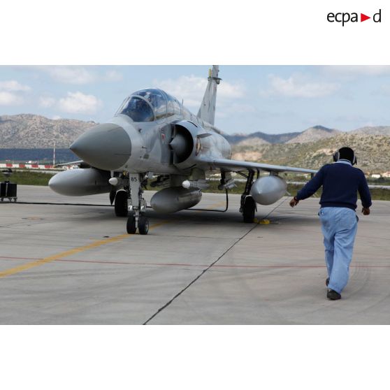 Pilotes qataris au cockpit de leur avion de combat Mirage 2000-5 QA 85 en phase d'allumage, prêts au départ en mission au signal du mécanicien de piste.