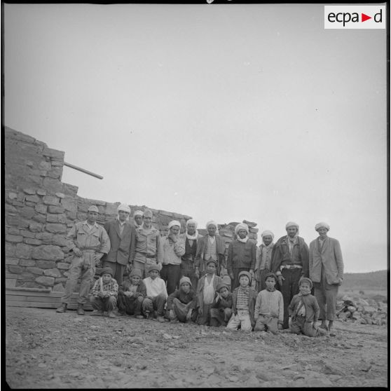 Portrait d'un groupe d'hommes et d'enfants du village. [légende d'origine]