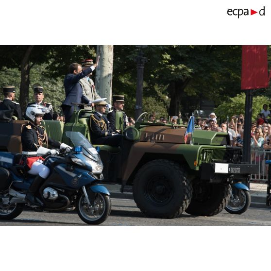 Monsieur Emmanuel Macron, président de la République française, remonte les Champs-Elysées à bord du "command car" lors du défilé militaire du 14 juillet 2018 à Paris.