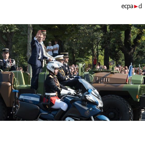 Monsieur Emmanuel Macron, président de la République française, remonte les Champs-Elysées à bord du "command car" lors du défilé militaire du 14 juillet 2018 à Paris.