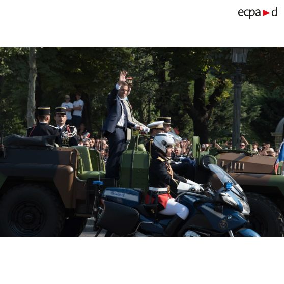 Monsieur Emmanuel Macron, président de la République française, remonte les Champs-Elysées à bord du "command car" lors du défilé militaire du 14 juillet 2018 à Paris.