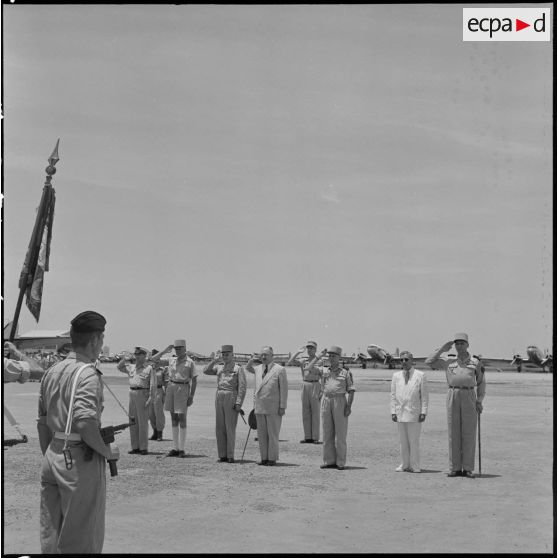 A l'occassion de l'arrivée du général Navarre sur l'un des aérodromes d'Hanoï, les autorités saluent le drapeau.