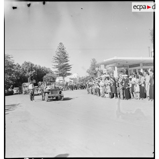 A Blida, la jeep willys transportant le colonel commandant le 65e RAA (régiment d'artillerie d'Afrique), précède les véhicules et artilleurs qui rentrent de la campagne de Tunisie.