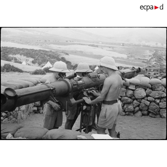 Des artilleurs d'une unité des FTA (forces terrestres antiaériennes) mesurent des distances avec un télémètre optique modèle 1931, lors d'une manoeuvre du CEF (corps expéditionnaire français).