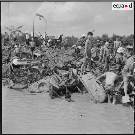 Récupération de la ferraille, jetée par la 11e CMRM (compagnie moyenne de réparation du matériel), dans le fleuve Rouge.