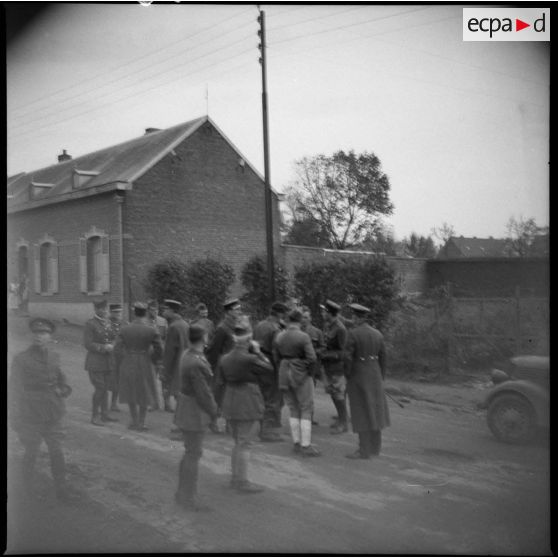 Photographie de groupe de soldats britanniques et français dans une rue.