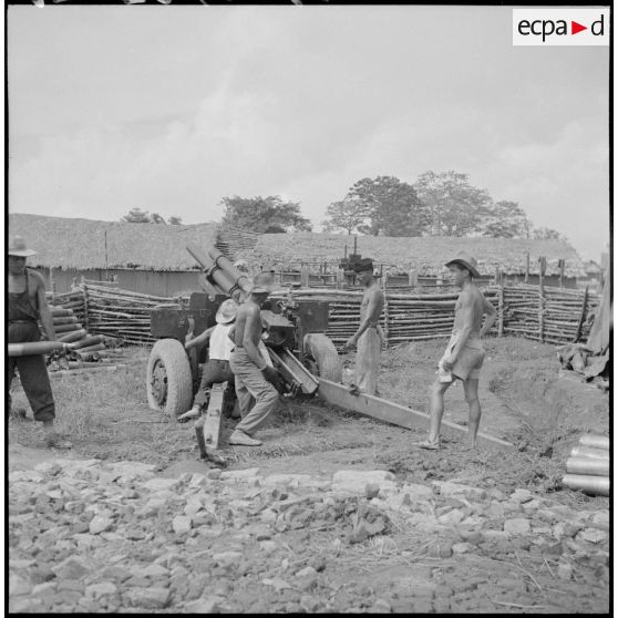 Chargement et mise en batterie par des artilleurs d'un M2A1 de 105 mm dans un poste au nord-ouest de Phu Ly.